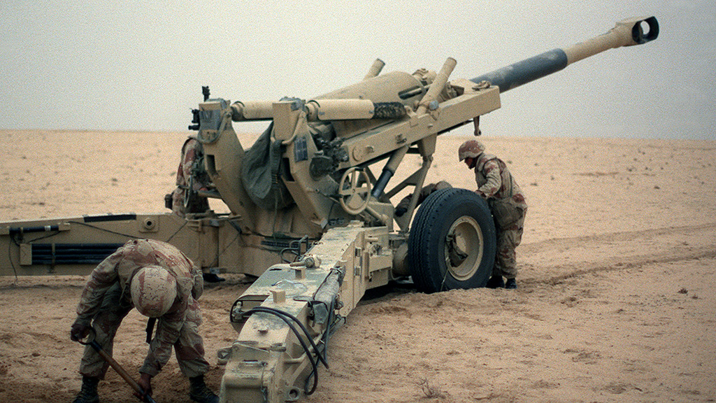 Marine artillerymen set up their M-198 155mm howitzer for a fire mission against Iraqi positions during Operation Desert Storm.